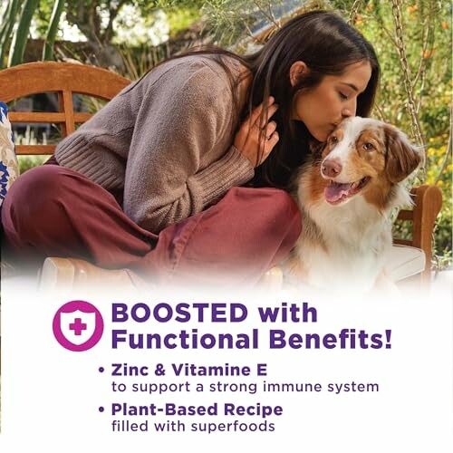 Woman kissing dog with text about boosted functional benefits including zinc, vitamin E, and plant-based recipe.